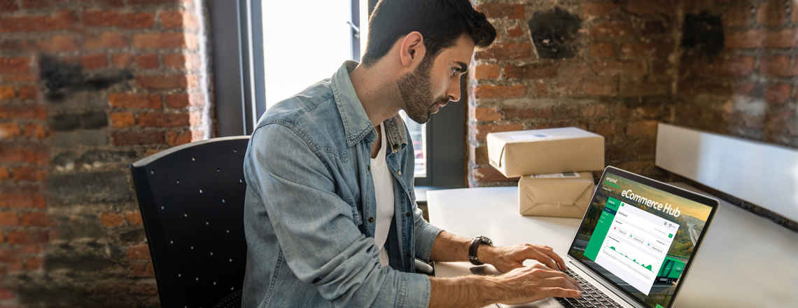 A person sitting at a desk using a computer