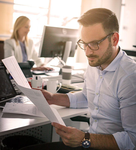 businessman in an office looking at documents