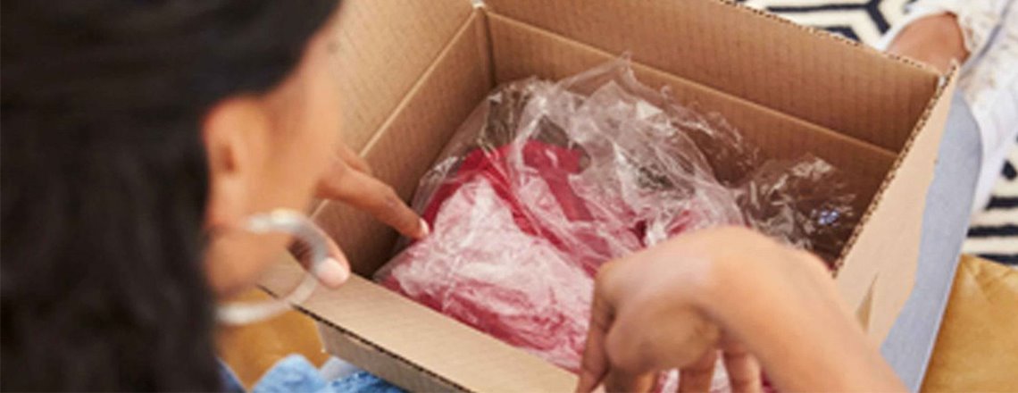 Woman opening up new purchase in a box