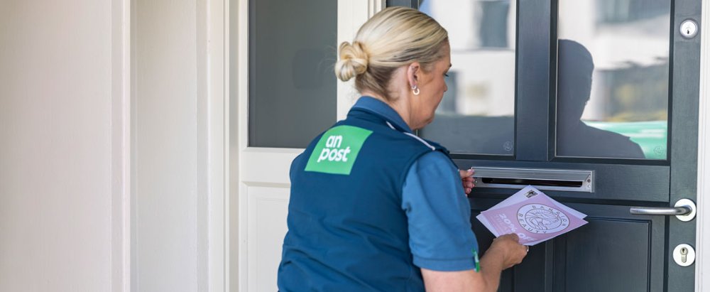 Audience‑targeted Direct Mail by An Post Commerce, showing a business reviewing addressed mail while using tools to navigate and plan campaigns.