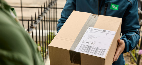 Buy and print postage online through the An Post Shop, showing a labelled parcel ready for posting with the correct postage applied.
