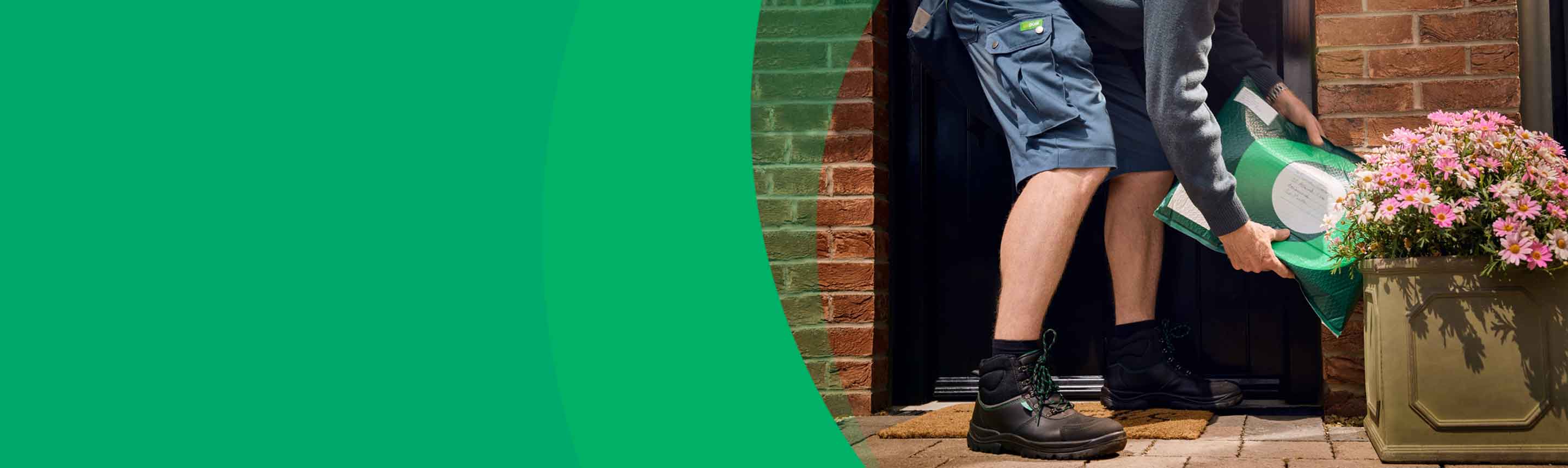 Postal operative places a package at a front door behind a flower pot