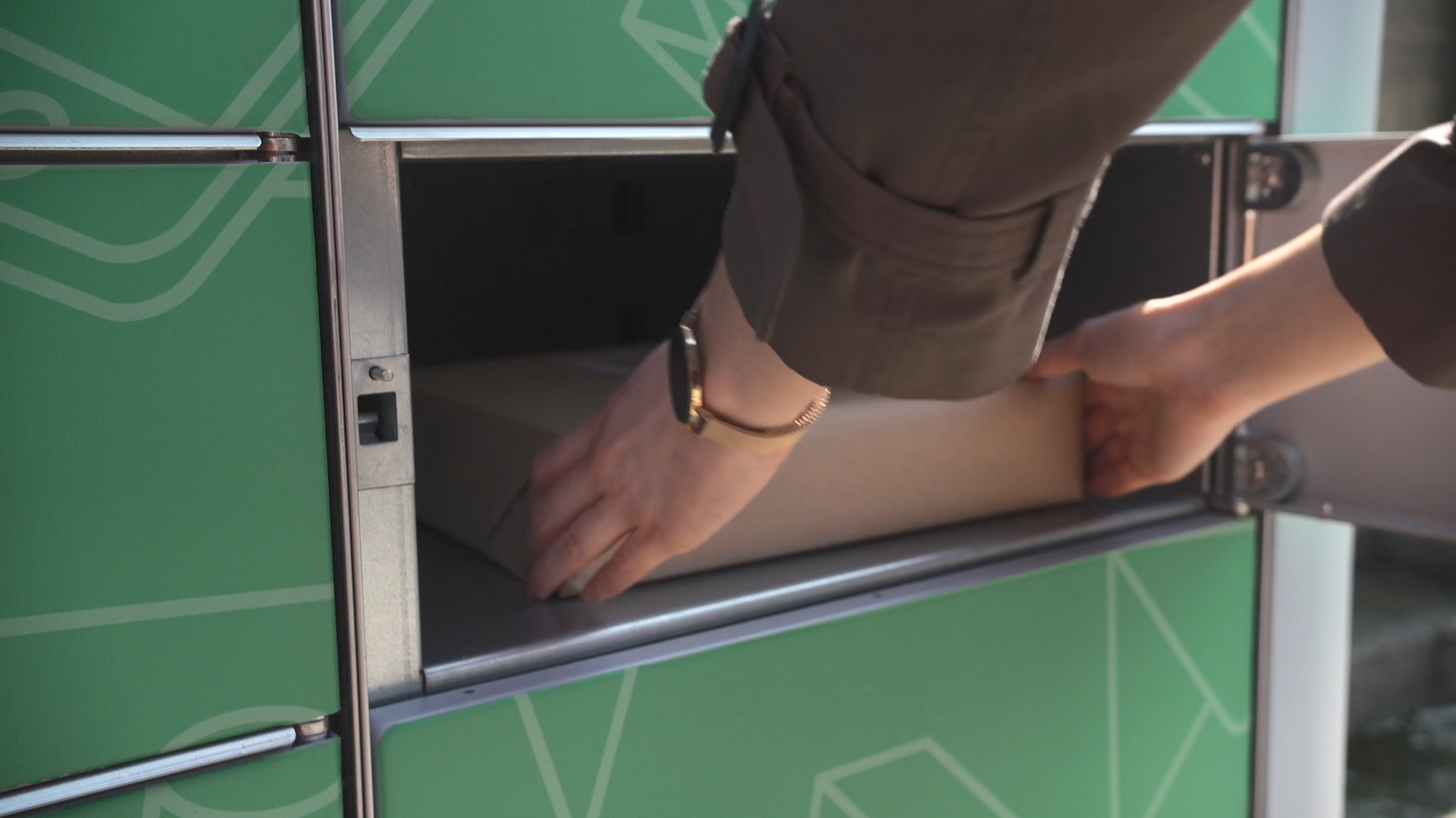 Woman collecting a parcel from An Post Parcel Locker
