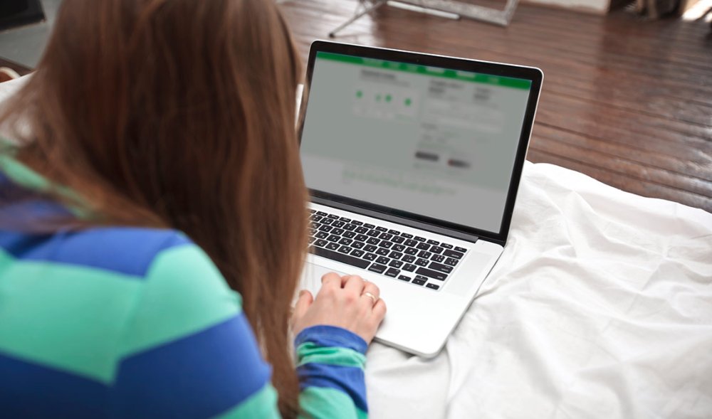 Person using a laptop to review Direct Mail pricing and campaign options