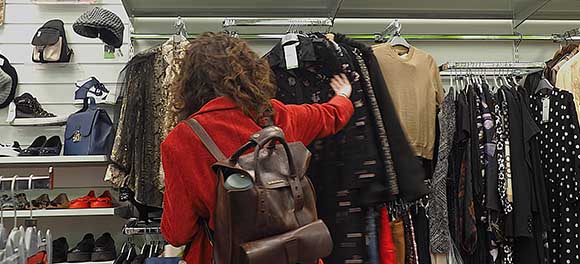 Woman browsing in Oxfam shop