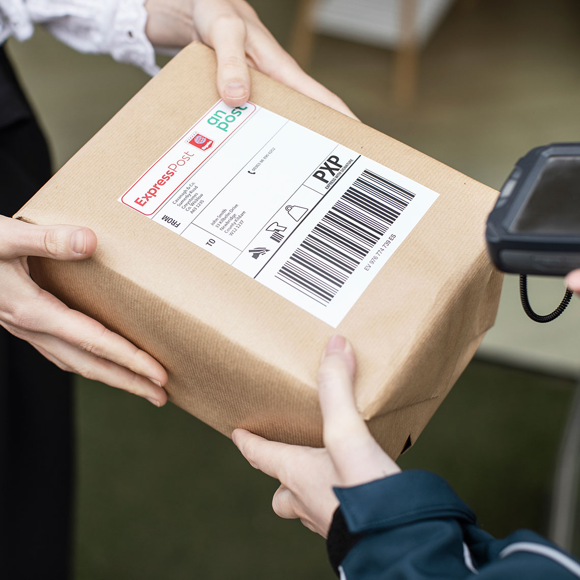 Package being scanned by postperson
